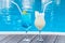 Two summer sweet cocktails by the pool. Blue lagoon and Pina colada in a glass with a straw. Mixed alcoholic drink. Beach party