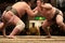 Two sumo wrestlers engaging in a fight