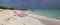 Two sun loungers stand near the sea in cloudy weather.