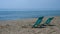 Two sunbeds on a deserted beach