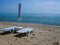 Two sunbeds on a deserted beach in conditions of social isolation