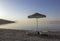 Two sunloungers on early morning beach