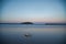 Two surfboards on the beach at twilight with kids swimming in the distance. Coffs Harbour, Australia