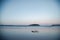 Two surfboards on the beach at twilight with kids swimming in the distance. Coffs Harbour, Australia