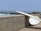 Two surfboards perched on a wall beside the sea, Lima