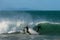 Two surfers nearly collide as they catch the same wave