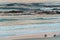 Two surfers sitting on Betty`s Bay beach at sunset in the Western Cape, South Africa