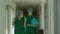 Two surgeon doctors discussion in front of the operating room for a new emergency case. Two Health Care Specialists Discuss,