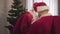 Two surprised Santa Clauses meeting on New Year`s eve. Portrait of confused men in red costumes with gift bags standing