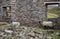 Two Swaledale sheep, (Ovis aries) resting in the ruins of Surrender lead smelt mill. North Yorkshire. England.