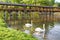 Two swans on river Danube and watermill and bridge in Kolarovo,