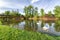 Two swans on river Danube and watermill and bridge in Kolarovo,