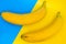 Two sweet banana against blue and yellow background
