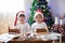 Two sweet boys, brothers, making gingerbread cookies house