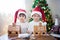 Two sweet boys, brothers, making gingerbread cookies house