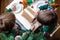 Two sweet boys, brothers, making gingerbread cookies house, decorating at home in front of the Christmas tree, child playing and