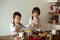 Two sweet children, boy brothers, preparing gingerbread cookies