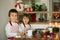 Two sweet children, boy brothers, preparing gingerbread cookies