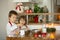 Two sweet children, boy brothers, preparing gingerbread cookies