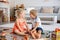 Two sweet children, siblings, playing with trains at home