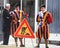 Two Swiss guards having a chit chat with a man beside a `men at work` road sign at Vatican City, Rome.