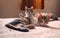 Two tabby, mixed breed cats relaxing on a bed, staring at the camera