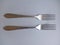 Two tablespoons of metal fork on a white background