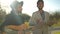 Two talented men in sunbeam playing guitar and ukulele singing in slow motion. Elegant Middle Eastern musicians enjoying