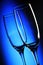 Two tall wine glasses on light background