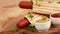 Two tasty grilled french hot dog with mustard and ketchup on vintage cutting board