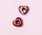 Two Tasty Luxury Bonbons in Shape of Hearts Chocolate Candies on Pink Background Sweets for Valentines Day Top View Minimal