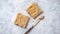 Two tasty peanut butter toasts placed on stone table