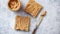 Two tasty peanut butter toasts placed on stone table