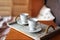 Two tea cups on wooden tray. Breakfast in bed. Romantic morning for a couple. Two ceramic cups of morning coffee