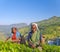 Two Tea Pickers Smile As They Pick Leaves
