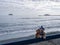 Two teddy bears in wool bobble hats and scarfs on winter beach