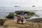 Two teddy bears in wool bobble hats on winter beach