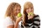 Two teen girlfriends eating green apples