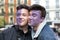 Two teenage boys with half face painted violet smiling during the manifestation of Women`s Day in the city center of Madrid, Spain