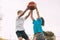 Two teenage boys play basketball on the Playground. Athletes fight for the ball in the game. Healthy lifestyle, sports