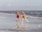 Two teenage friends and brothers enjoy jogging along the beach