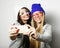 Two teenage girls friends in hipster outfit make selfie