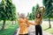 two teenage girls in headscarves doing hand stretches as they get ready before a workout