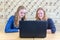 Two teenage girls looking at computer in chemistry lesson