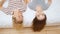 Two teenage girls lying on bed in cozy room and having fun.