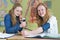 Two teenage girls measuring blood pressure in biology lesson