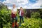 Two teenage girls posing in garden with gardening tools