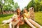 Two teenage girls sitting with three dogs in park