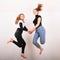 Two teenage girls smiling and jumping friends