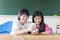 Two teenage girls student watching the phone in classroom